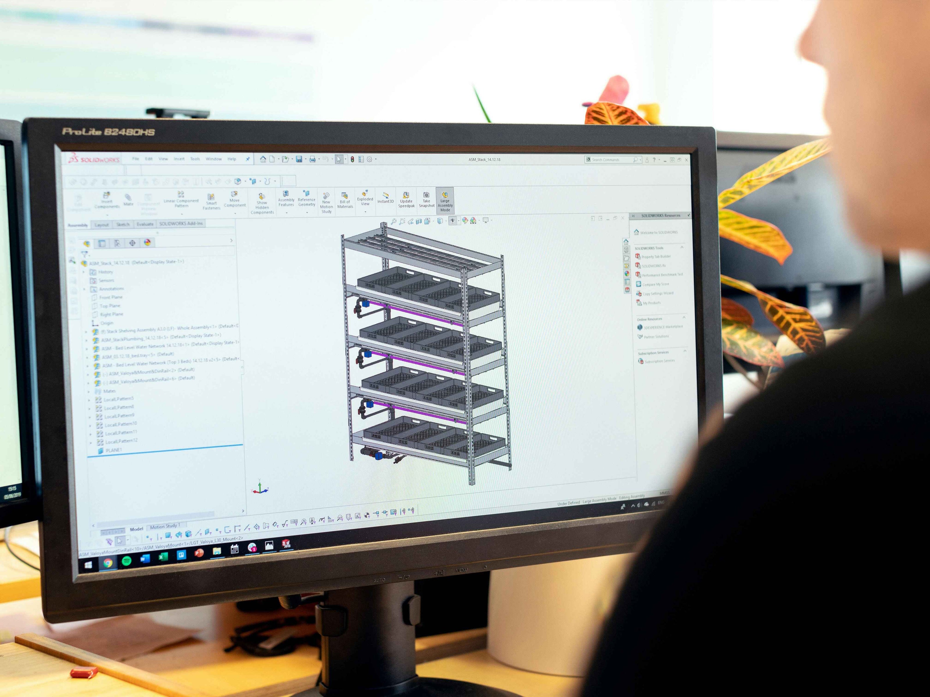 Engineer designing industrial racking system using 3D CAD software on computer