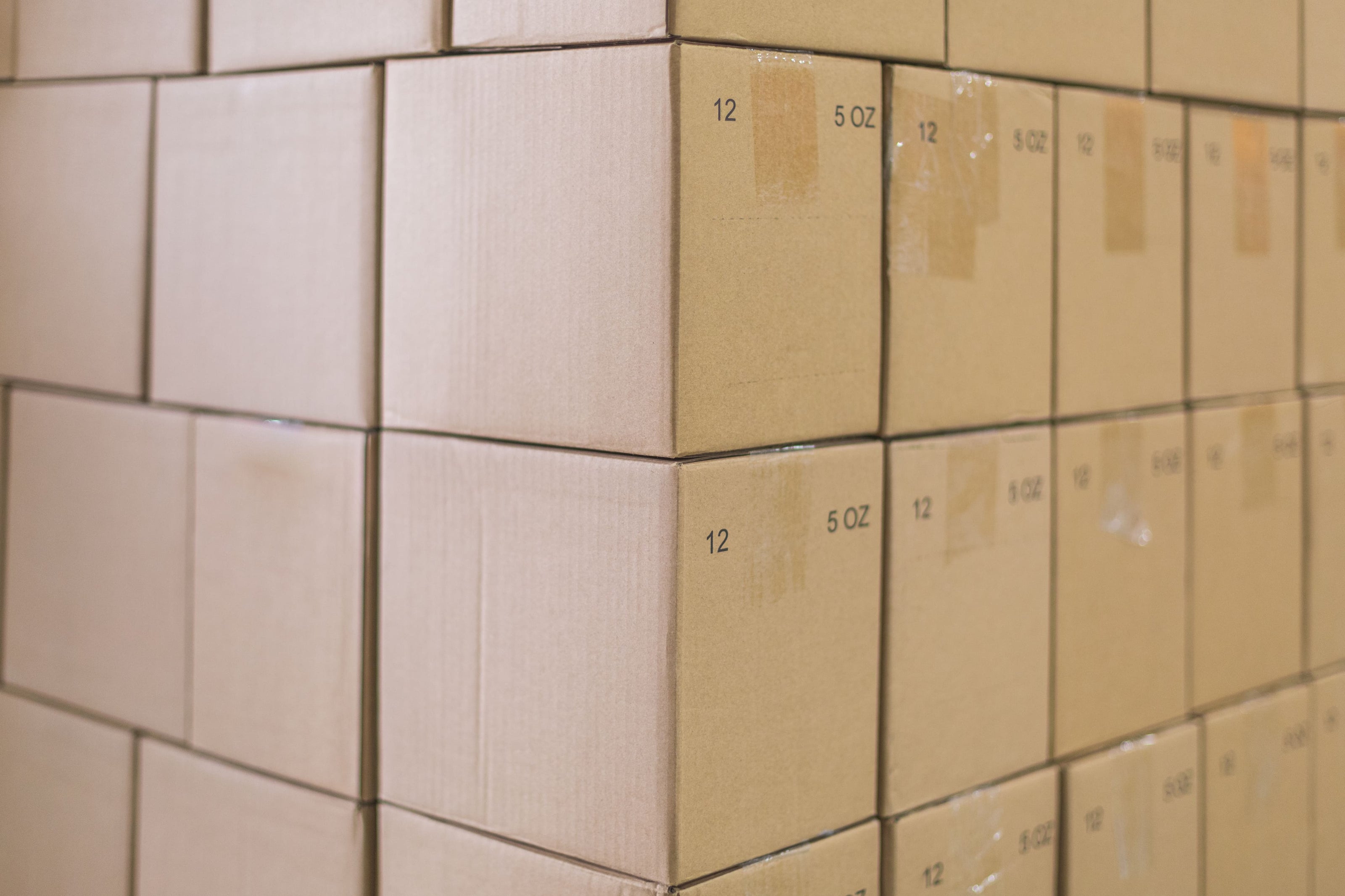Stacked cardboard shipping boxes in a warehouse
