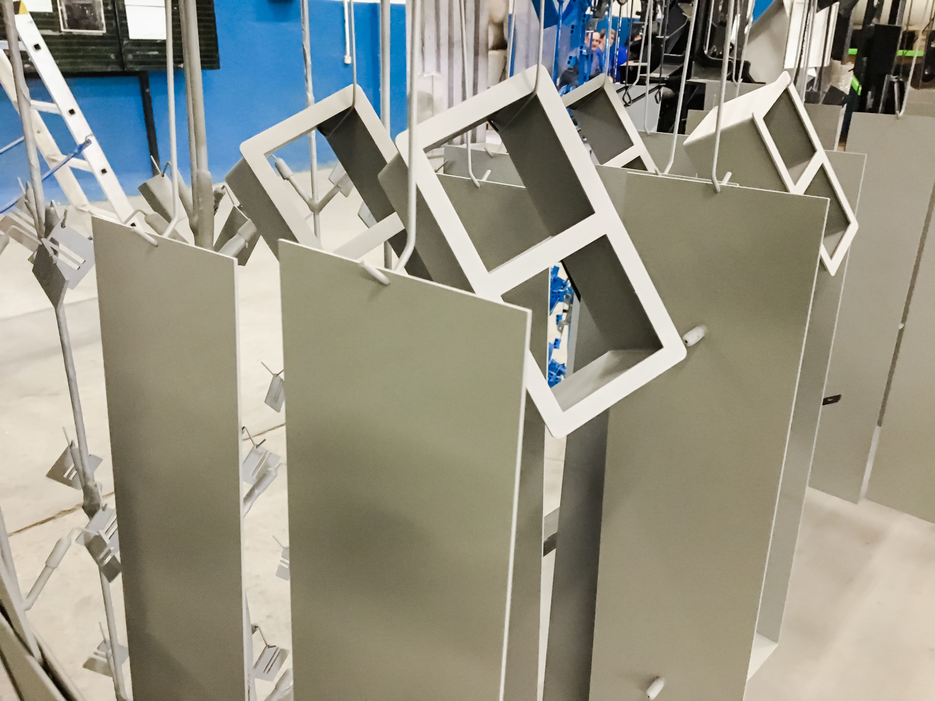 Metal components hanging in a workshop after powder coating process